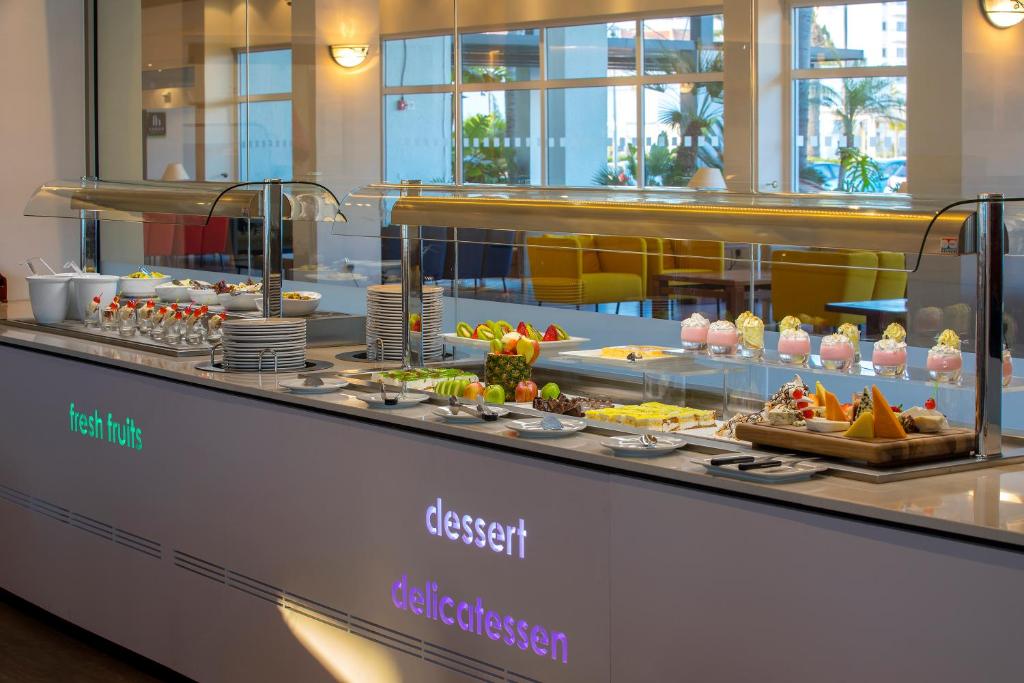 a buffet line with many different types of food at Faros Hotel Ayia Napa in Ayia Napa