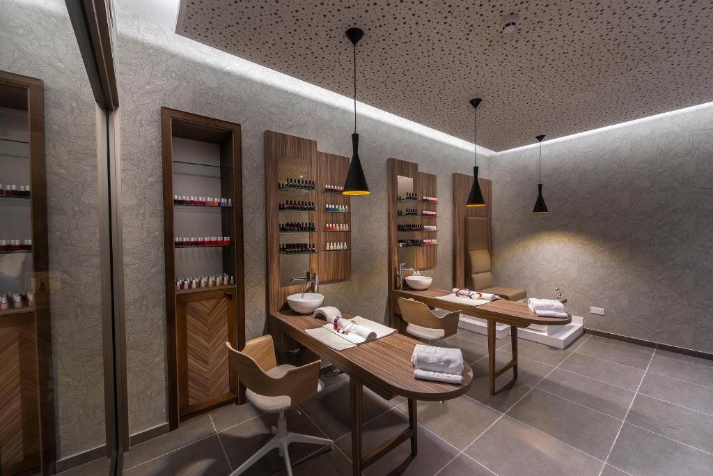 a wine tasting room with two tables and chairs at Faros Hotel Ayia Napa in Ayia Napa