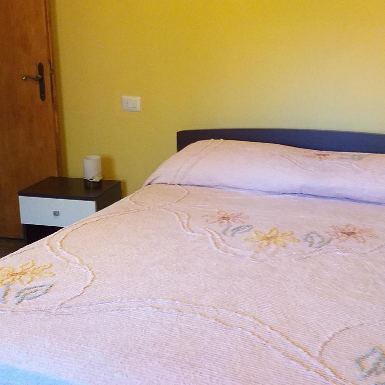 Łóżko lub łóżka w pokoju w obiekcie LA CASETTA DELLA NONNA