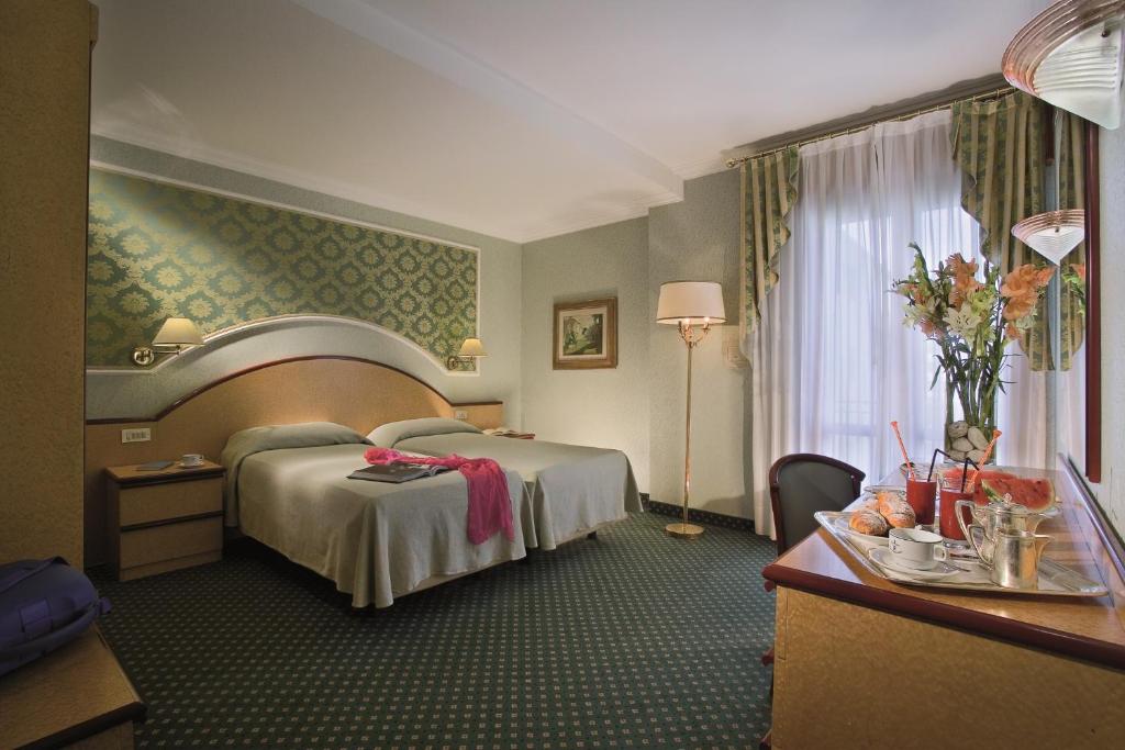 Postel nebo postele na pokoji v ubytování Palace Hotel Meggiorato