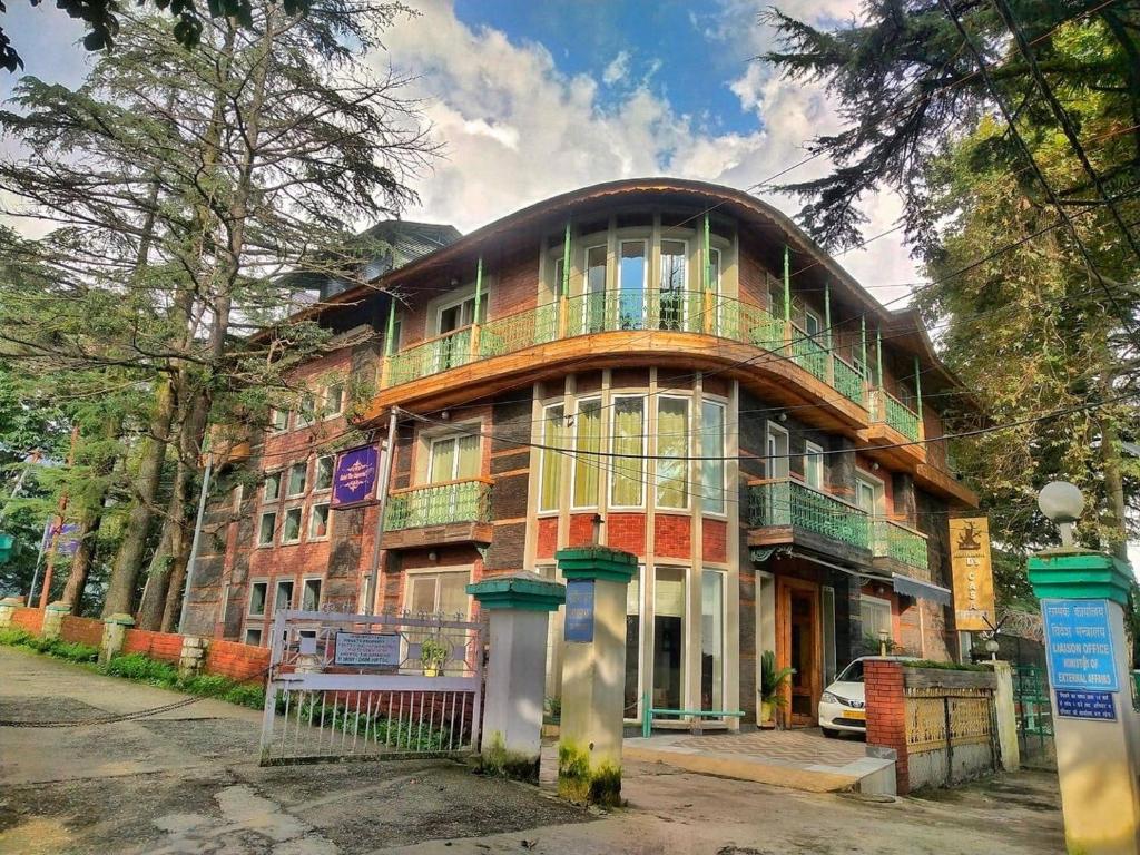 a large building with a balcony on top of it at D's Casa in McLeod Ganj