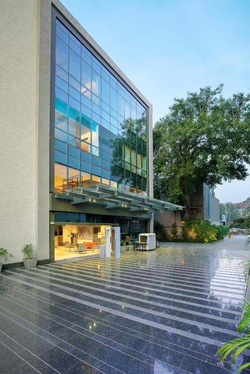 a large glass building with stairs in front of it at Park Inn by Radisson Gwalior in Gwalior