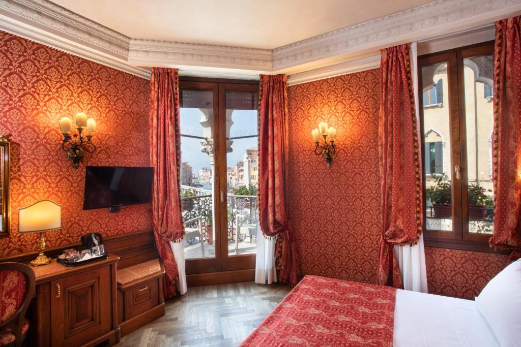 Łóżko lub łóżka w pokoju w obiekcie Palazzina Veneziana