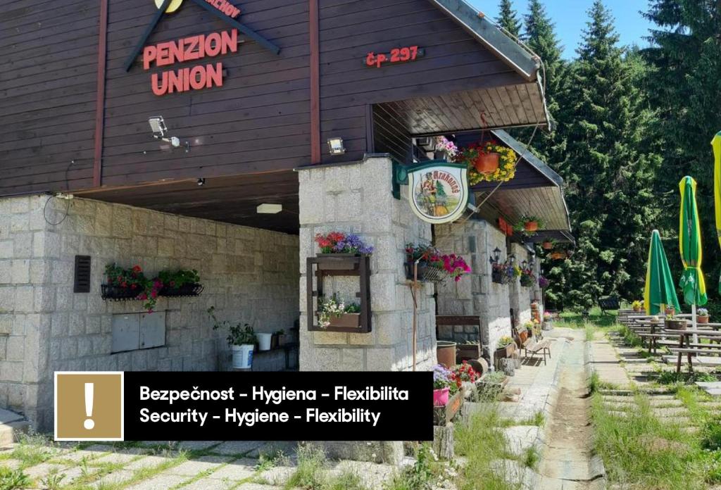 a building with a sign on the side of it at Penzion Union Harrachov in Harrachov