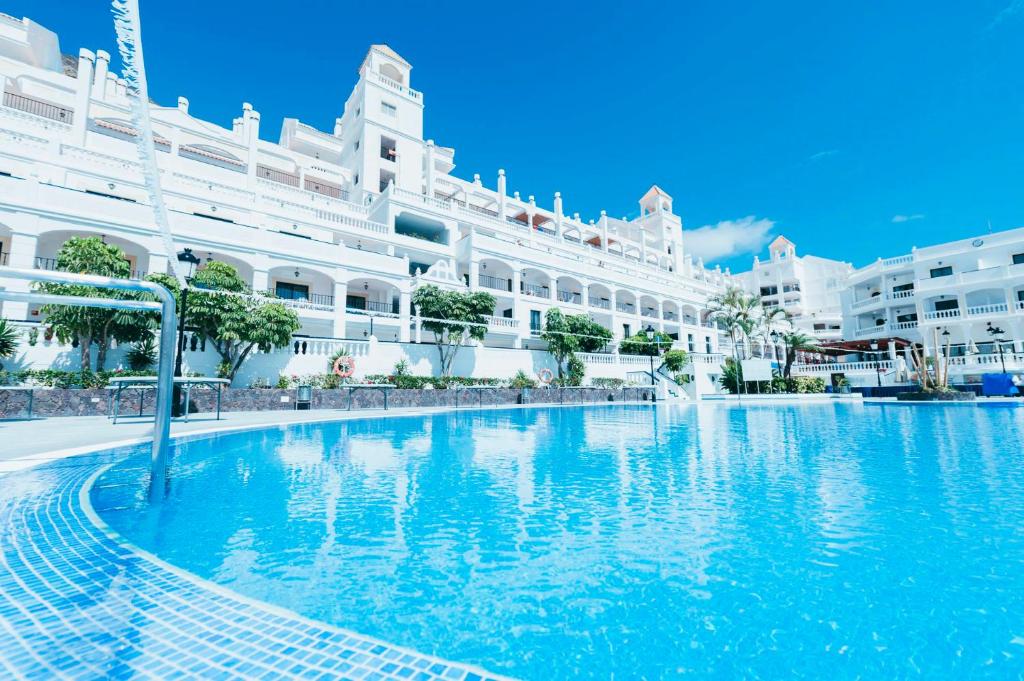 a large swimming pool in front of a large building at Hollywood Mirage - Excel Hotels & Resorts in Los Cristianos