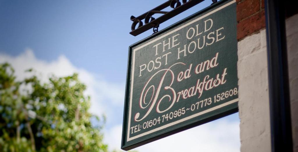 a sign for theost house old house old and strawberryhit at The Old Post House in Naseby