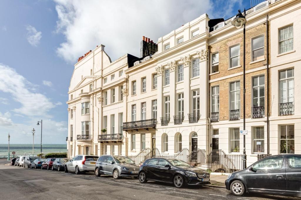 a large white building with cars parked in front of it at Luxury Mansion Townhouse with Private Cinema in Brighton & Hove