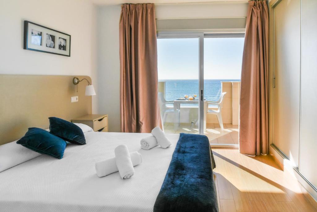 a bedroom with a bed with a view of the ocean at Vegasol Playa A.T in Fuengirola