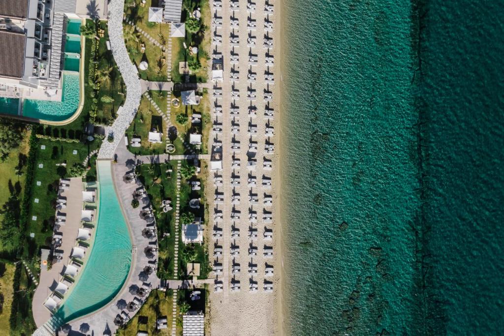 an aerial view of a parking lot next to the ocean at Blue Carpet Luxury Suites in Pefkochori