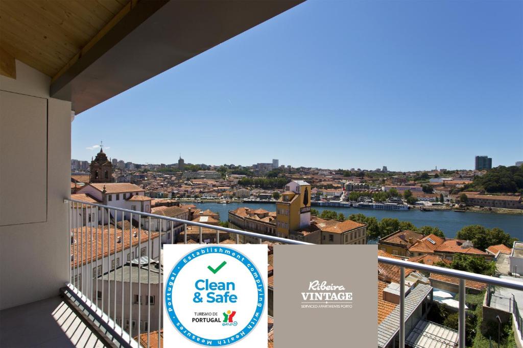 a sign on a balcony with a view of a city at RVA - Sao Joao Novo Apartments in Porto