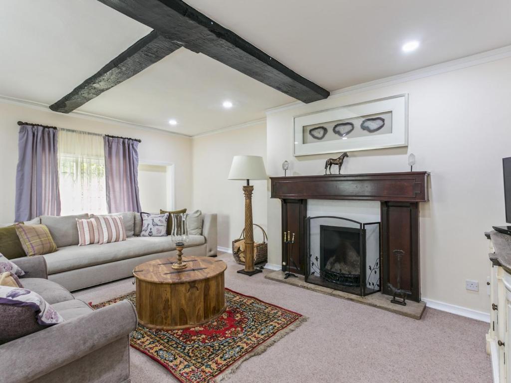 a living room with a couch and a fireplace at Historical Cottage Escape BIG in Burnham