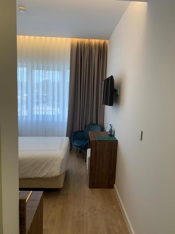 Postel nebo postele na pokoji v ubytování Hotel Moutados