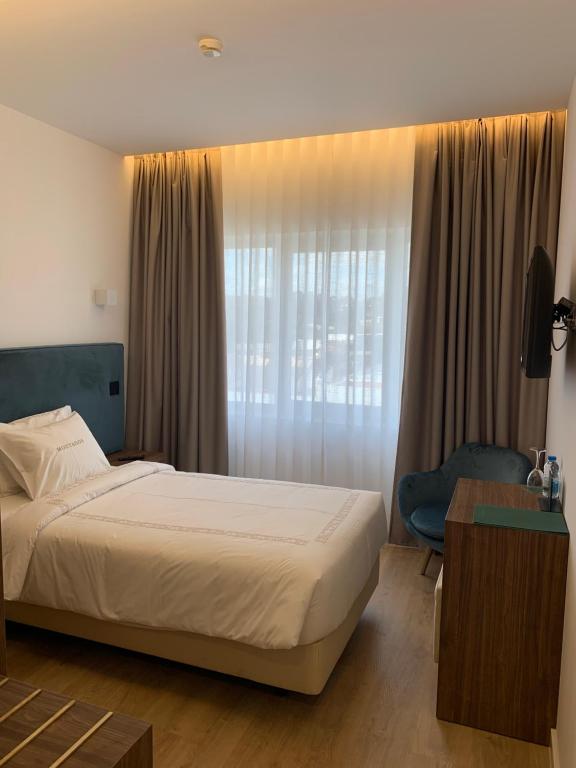 Postel nebo postele na pokoji v ubytování Hotel Moutados