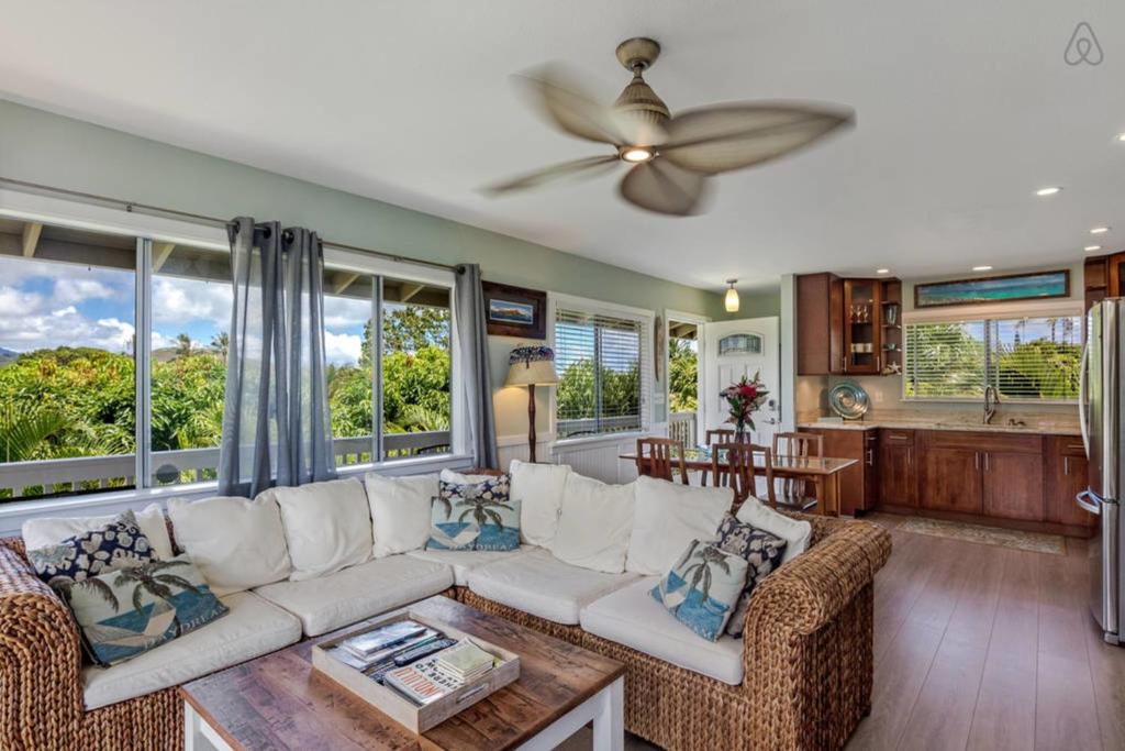 a living room with a white couch and a ceiling fan at Last Minute Opening! Island Style Homebase 2BR 1BA AC Full Kitchen in Kailua