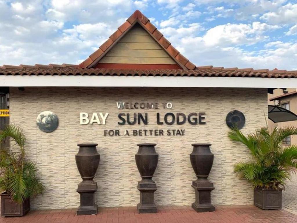 a sign for the bay sun lodge for a better stay at Bay Sun Lodge in Richards Bay