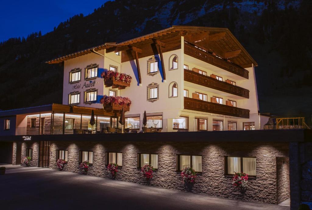 a large building with flowers in front of it at Hotel Arabell in Lech am Arlberg