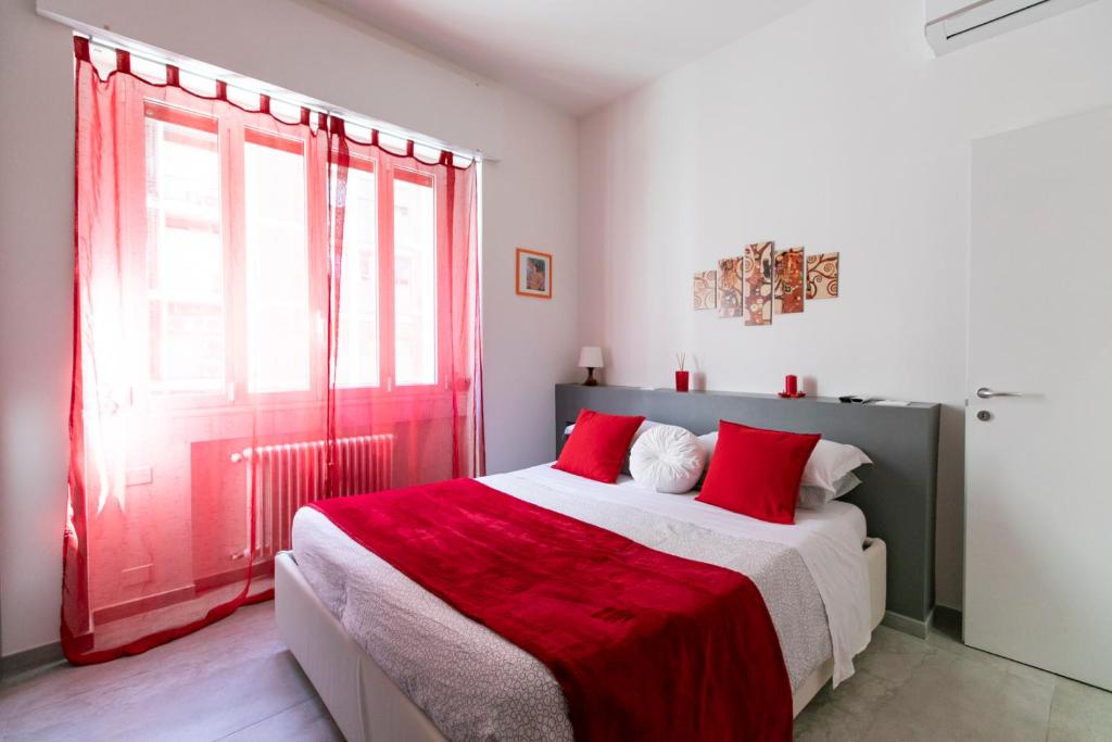 a bedroom with a red door and a large bed at Marconi Dreams in Bologna