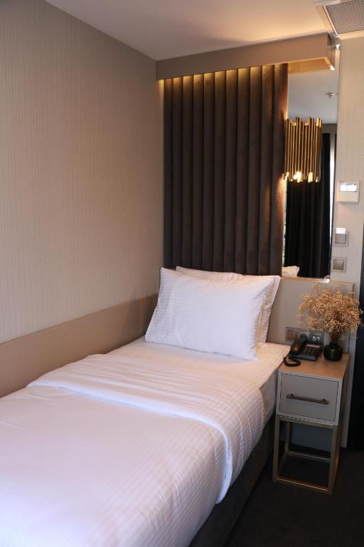 Postel nebo postele na pokoji v ubytování Air Boss Giresun City Hotel