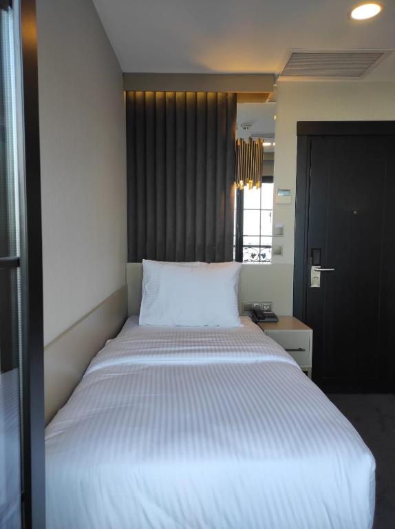 Postel nebo postele na pokoji v ubytování Air Boss Giresun City Hotel