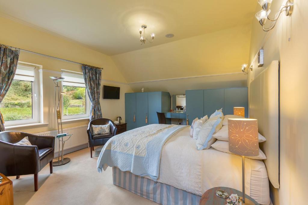 a bedroom with a bed and a desk and a chair at Dún Ard in Dungarvan