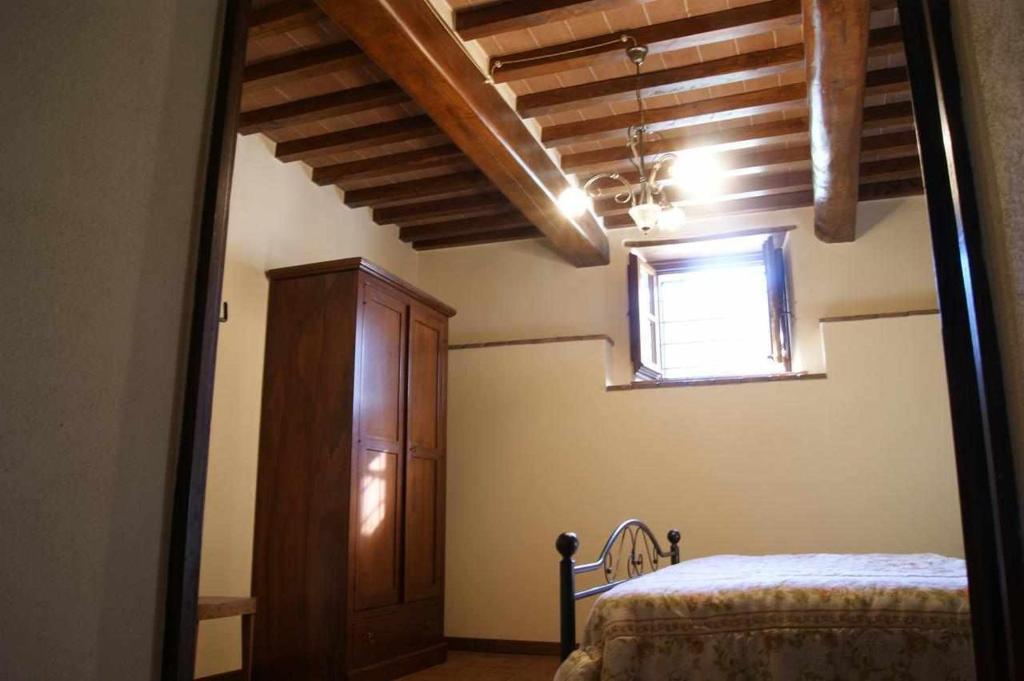 Posteľ alebo postele v izbe v ubytovaní Appartamenti con cucina nelle colline toscane