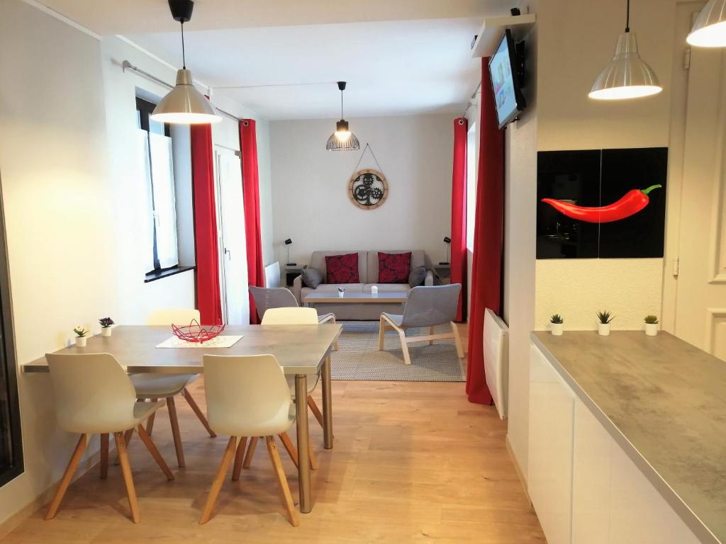 a kitchen and living room with a table and chairs at Gite Côté Cour Colmar in Colmar