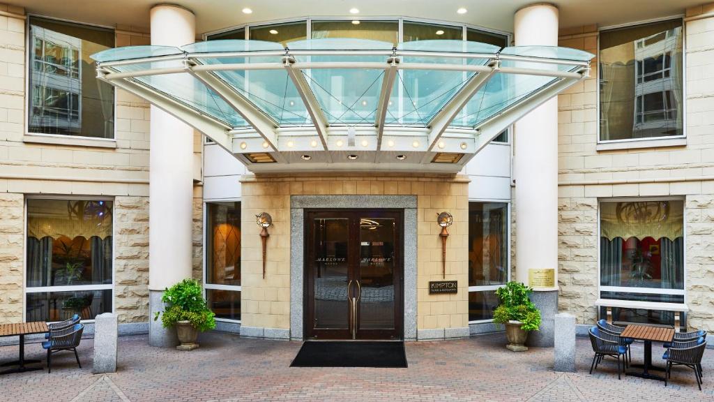 a glass entrance to a building with a revolving door at Kimpton Marlowe, an IHG Hotel in Cambridge