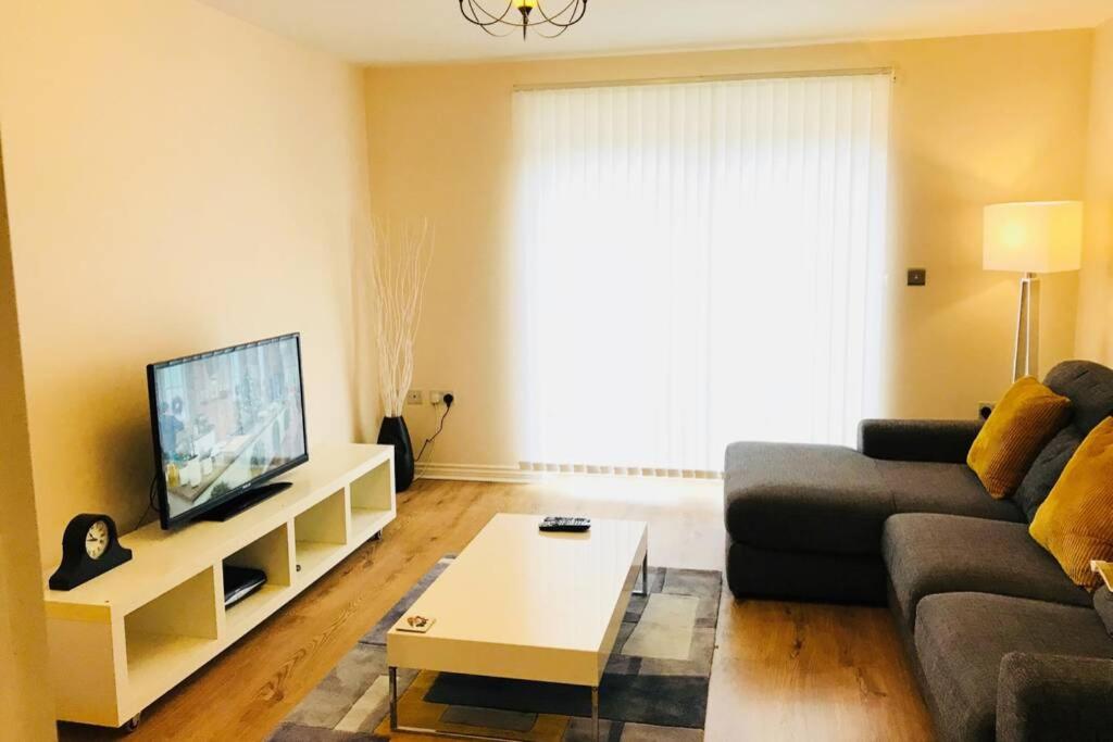 a living room with a couch and a tv at Smartrips Home Coventry in Parkside