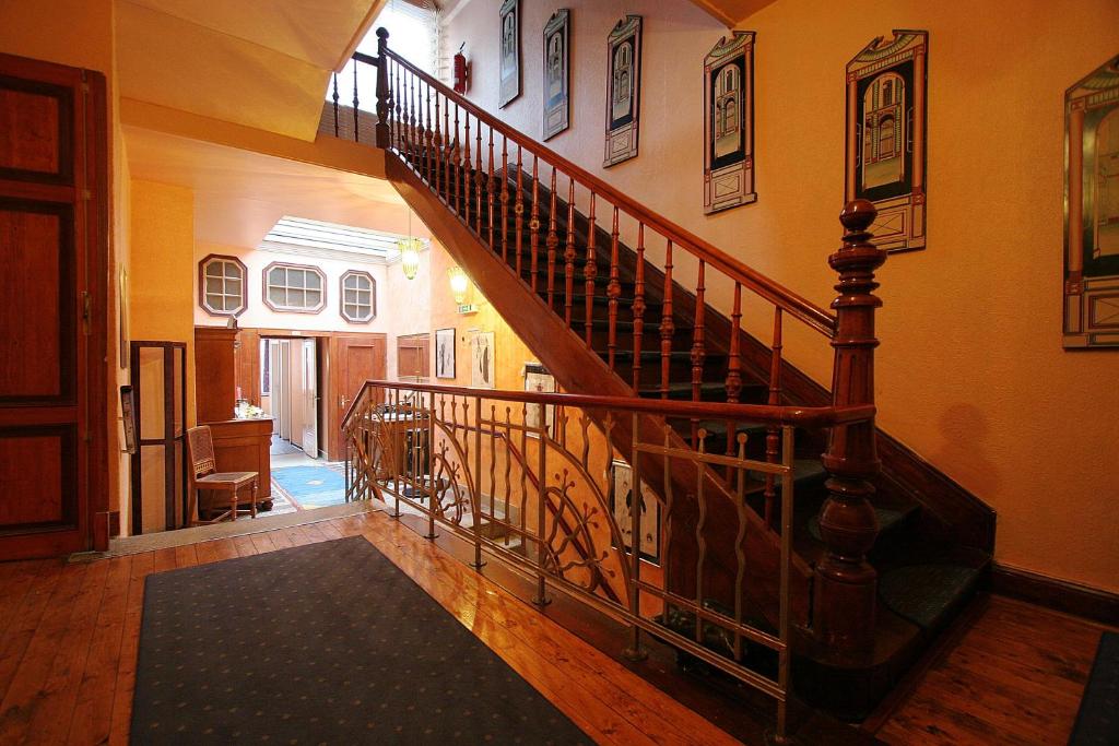a hallway with a spiral staircase in a house at Hotel Reuter in Haiger