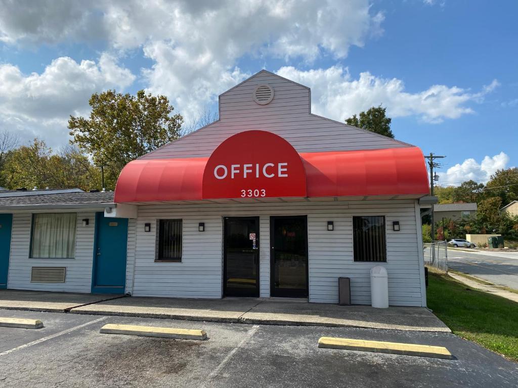 a office building with a red awning on a street at Red Carpet Inn Greensboro in Greensboro