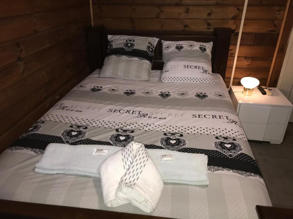 a bed with two pillows and towels on it at Chambre1 Résidence Beauregard in Koungou