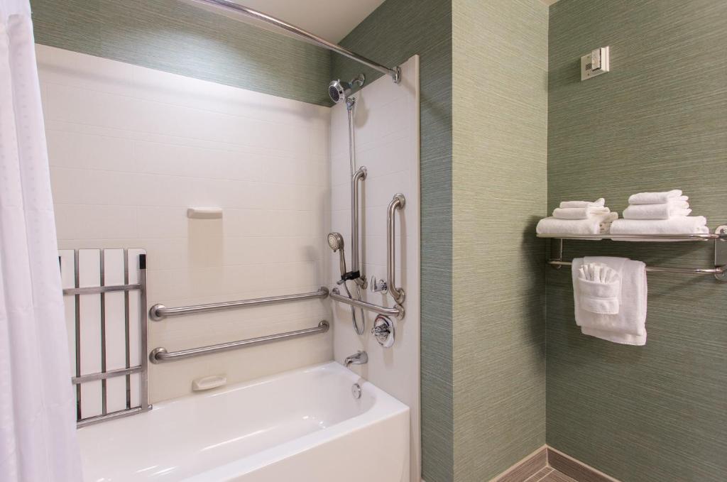 a bathroom with a white toilet and a shower at Holiday Inn Texarkana Arkansas Convention Center by IHG in Texarkana
