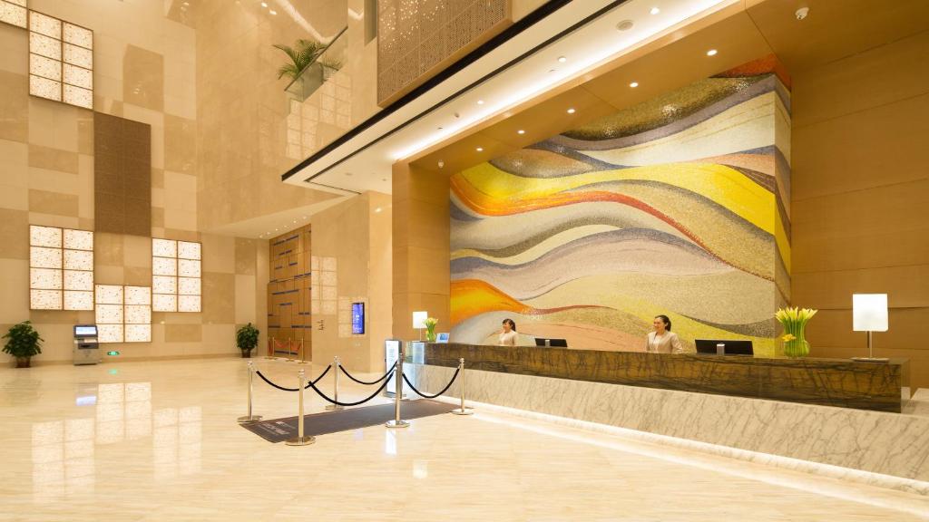 a lobby with a large painting on the wall at Holiday Inn Haikou West Coast, an IHG Hotel in Haikou