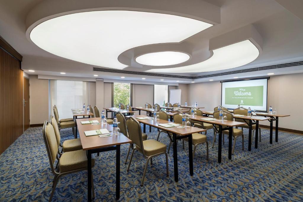 a conference room with tables and chairs and a screen at Holiday Inn Istanbul Old City by IHG in Istanbul