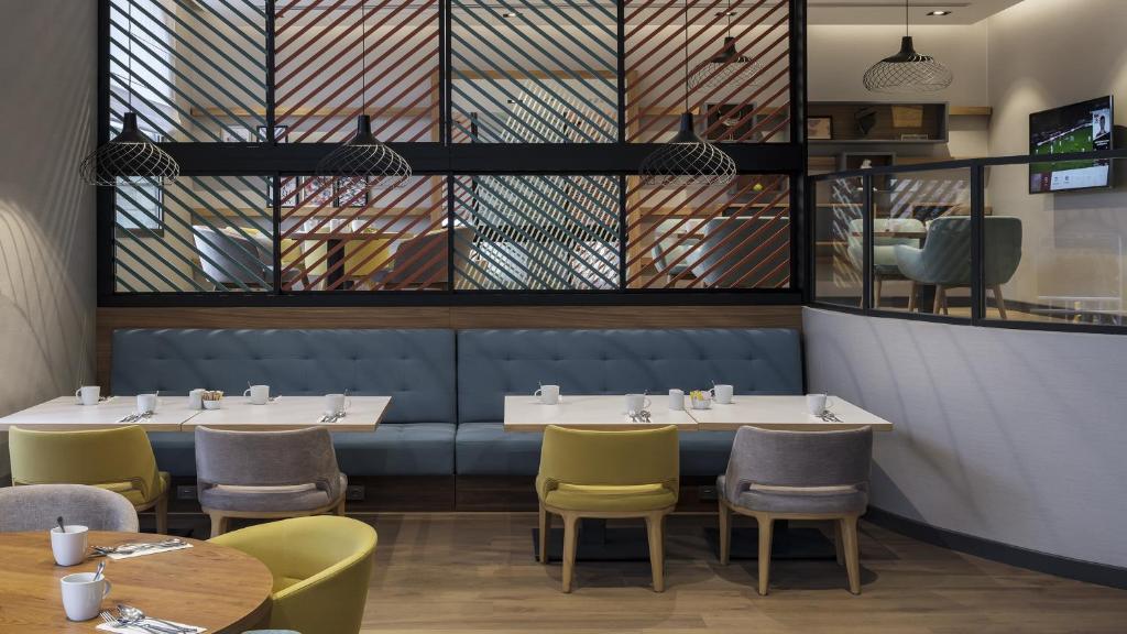 a dining room with two tables and chairs at Holiday Inn Istanbul Old City by IHG in Istanbul