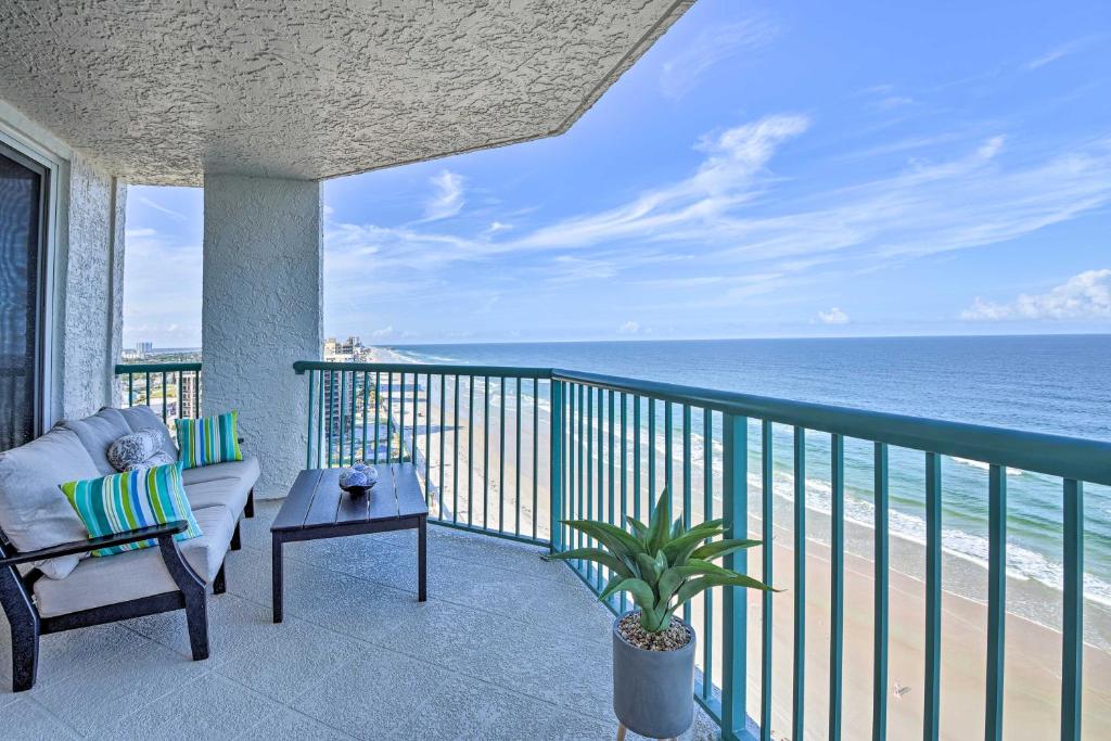 a balcony with a couch and a view of the ocean at Luxe Daytona Beach Resort Retreat with Ocean Views! in Daytona Beach Shores
