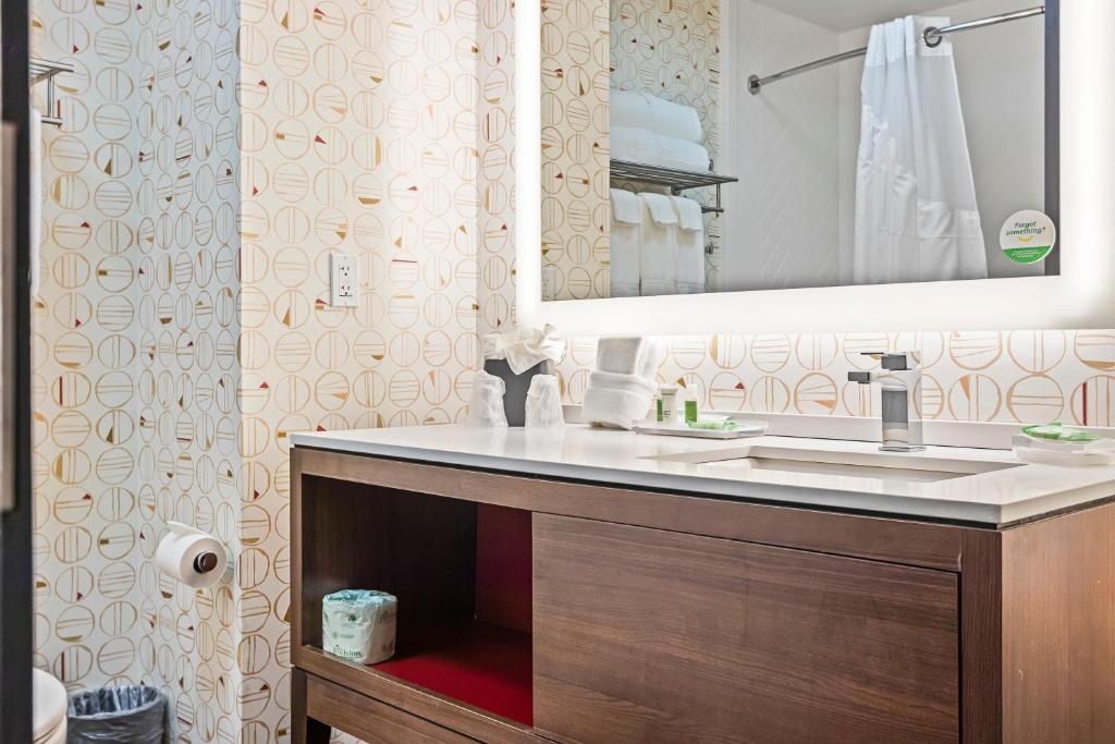 a bathroom with a sink and a mirror at Holiday Inn - St. Petersburg West by IHG in St Petersburg