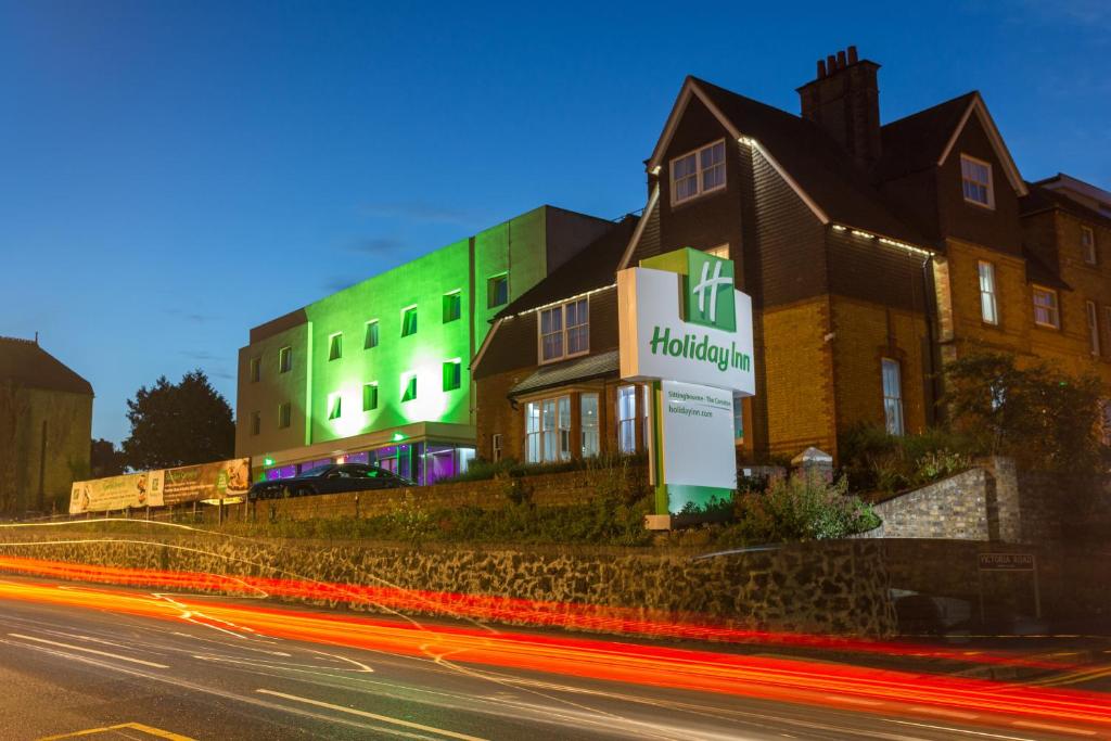 a building with a sign in front of a street at Holiday Inn Sittingbourne, an IHG Hotel in Sittingbourne