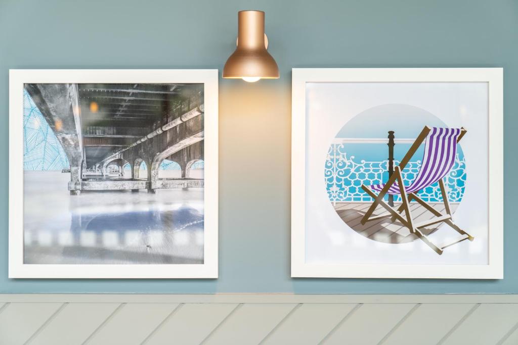 two framed photographs hanging on a wall in a room at Holiday Inn Bournemouth by IHG in Bournemouth