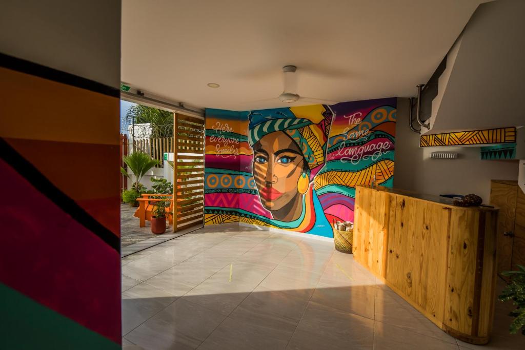 a room with a mural on the wall at Makena La Boquilla Beach Hostel in Cartagena de Indias