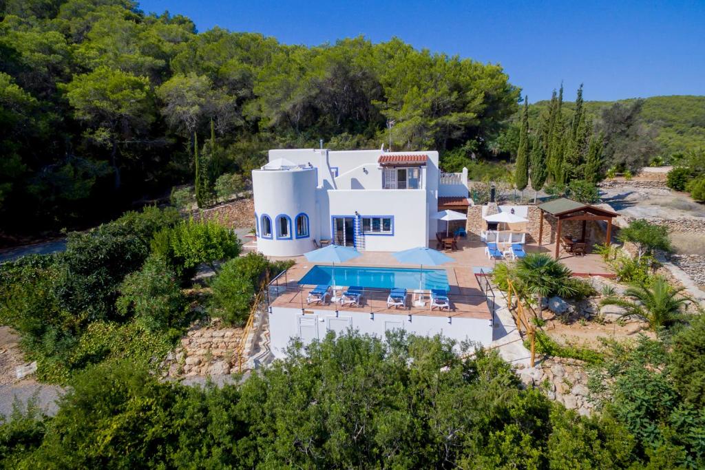an aerial view of a white house with a swimming pool at Charming villa with pool, Can Toni Mateu. in Sant Carles de Peralta