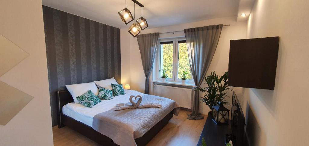 Dormitorio pequeño con cama y ventana en Apartament A&S Widok w Wałbrzychu en Wałbrzych