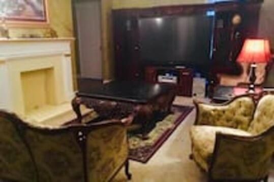 a living room with a large television and a couch and chairs at 3 BEDROOM SLEEPs 8 NICE SPACIOUS APARTMENT B 89 in Montgomery