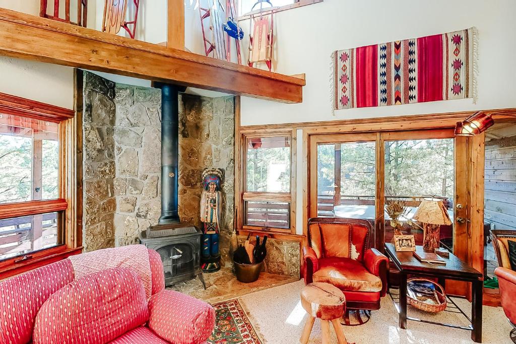 a living room with a couch and a fireplace at Appaloosa Retreat in Pagosa Springs