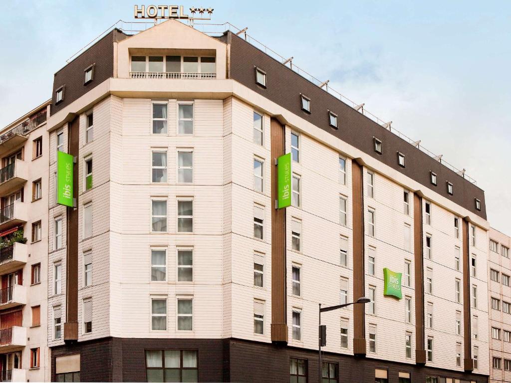 a building with green signs on the side of it at ibis Styles Paris Mairie de Montreuil in Montreuil