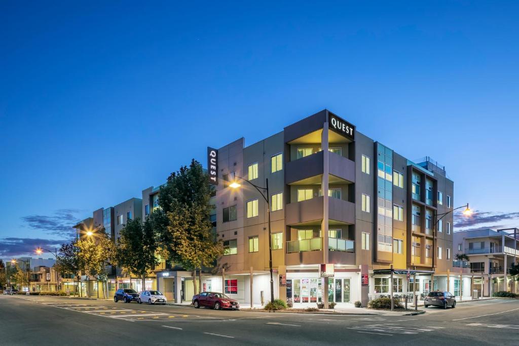 an apartment building on a city street at night at Quest Mawson Lakes in Adelaide