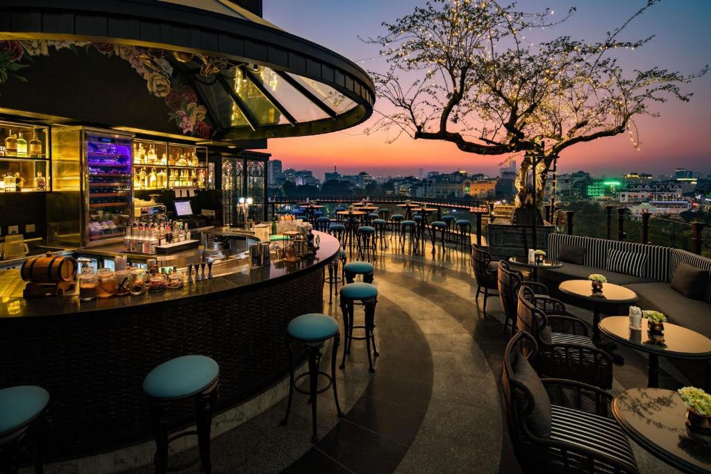 a bar on the roof of a building with a view at La Sinfonía del Rey Hotel & Spa in Hanoi