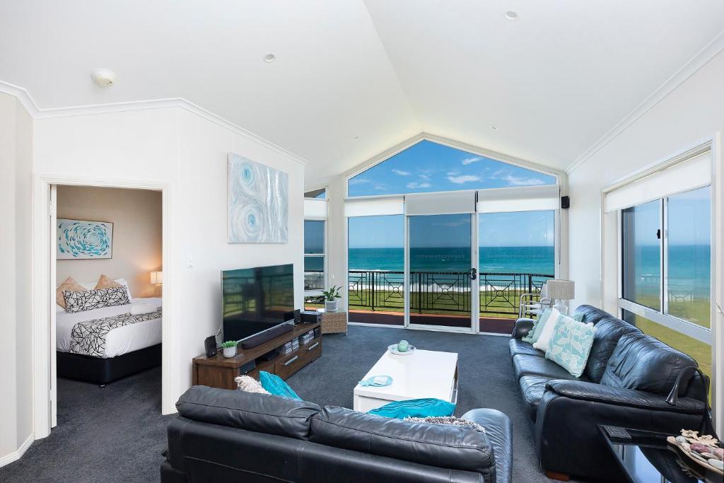 a living room with a view of the ocean at Meridian Beachside Apartments in Old Bar