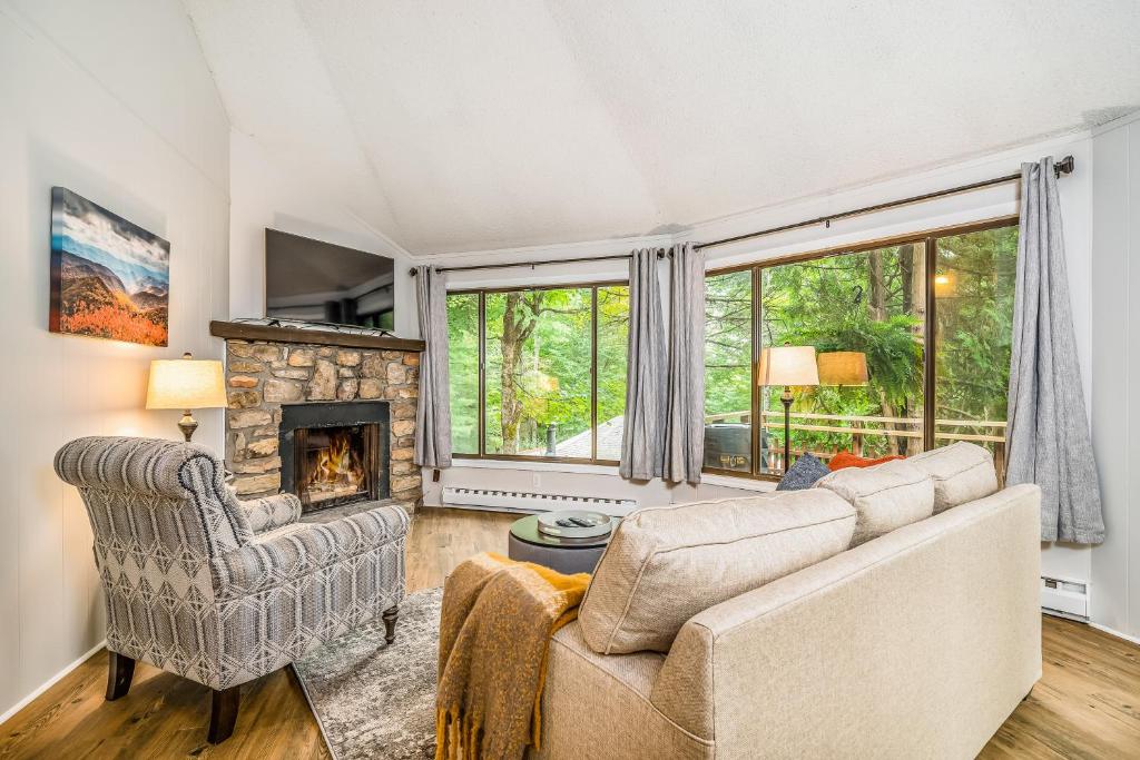 a living room with a couch and a fireplace at 102 Village Cluster in Beech Mountain