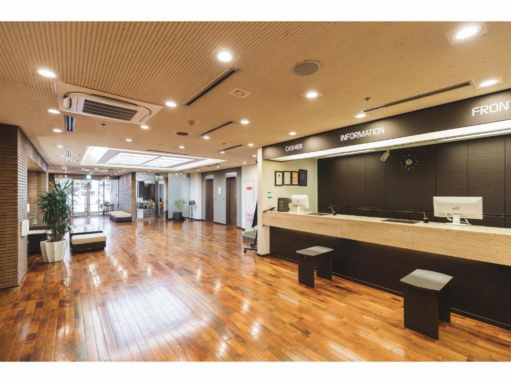 a lobby with a reception desk in a building at Cityroute Hotel in Osaka